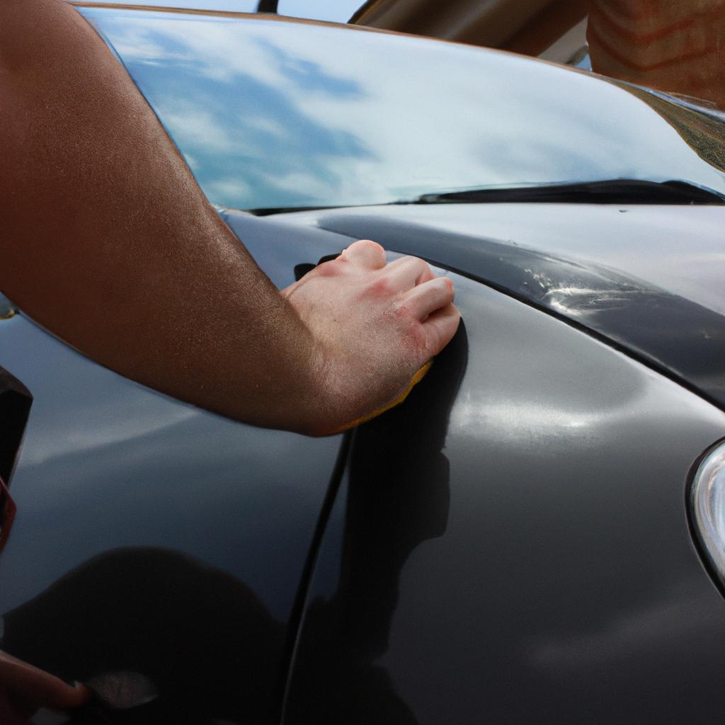 Person detailing a car exterior